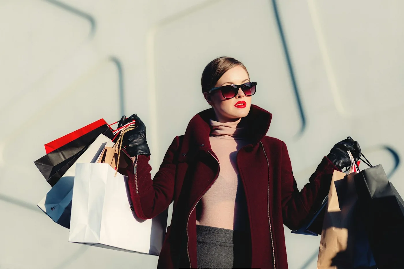 City shopper holding bags while wearing sunglasses